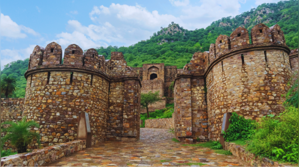 The ruins of Bhangarh Fort under a cloudy sky