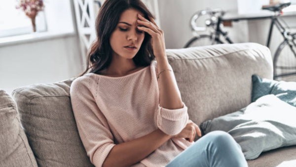 Exhausted woman sitting on a couch
