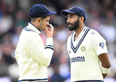 Jasprit Bumrah with Shubman Gill discussing strategy on the field.
