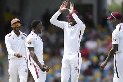 Roston Chase congratulates Shamar Joseph on Day 1