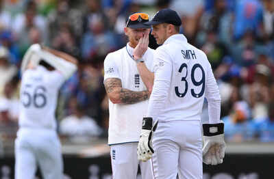 Ben Stokes and Jamie Smith in discussion during a match.